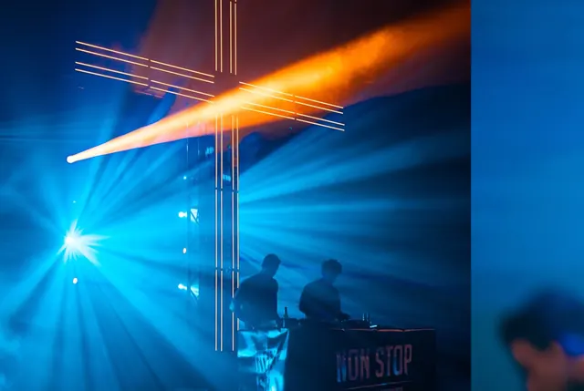 Blue lasers and a light cross over the NON STOP stage