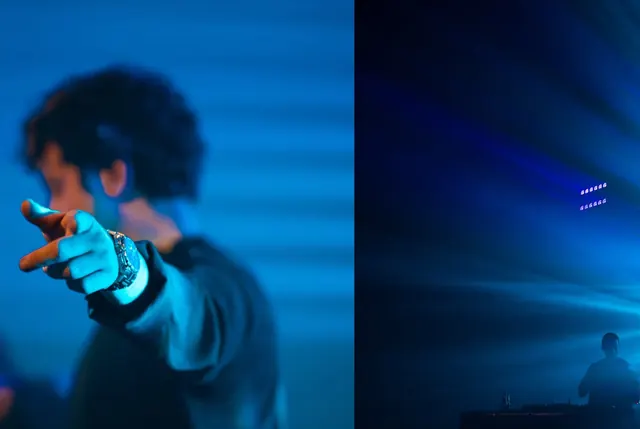 TAPE member pointing at the crowd in blue light at NON STOP