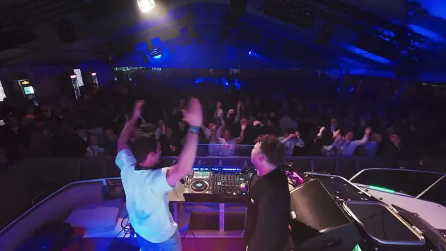 Packed Schippersweekend tent with hands up in front of the booth